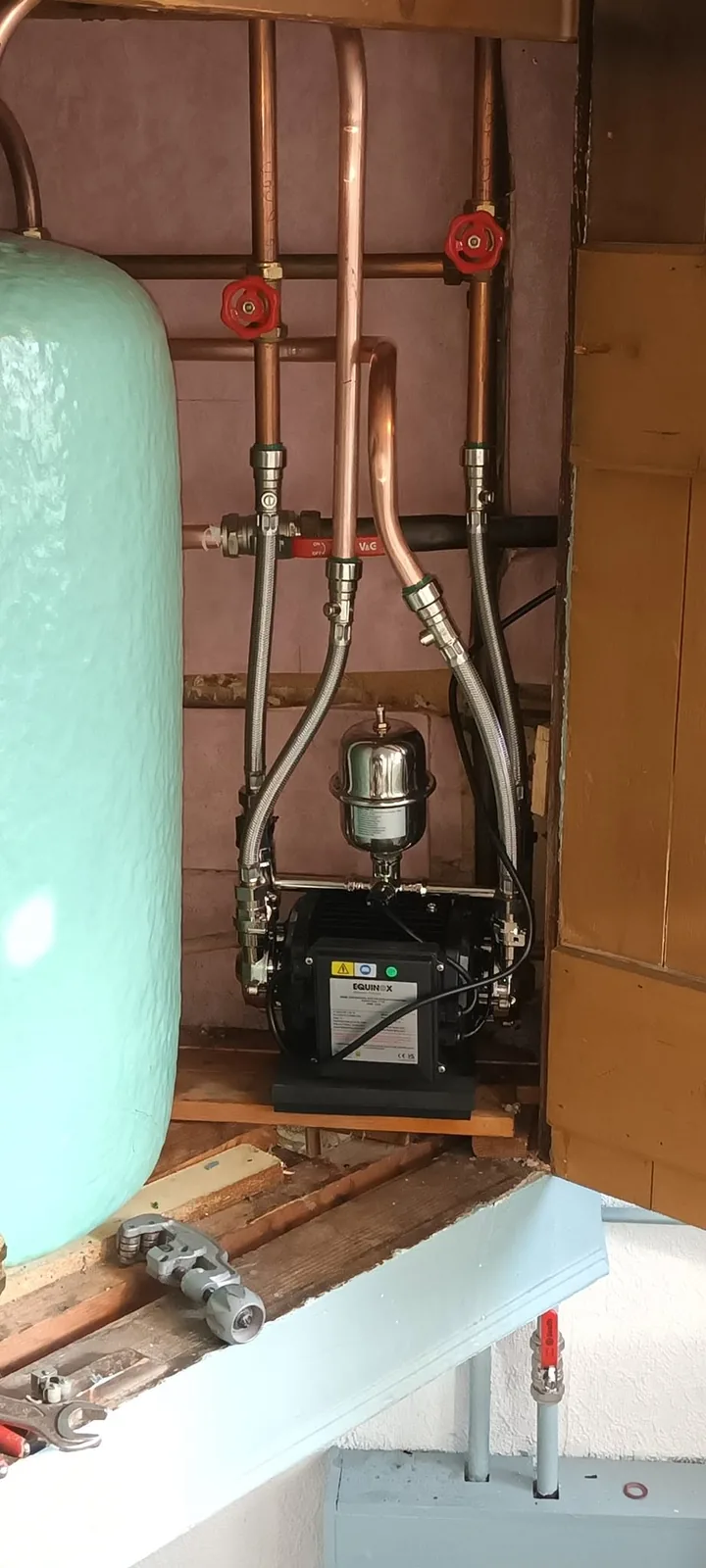 Shower pump installed alongside a hot water cylinder