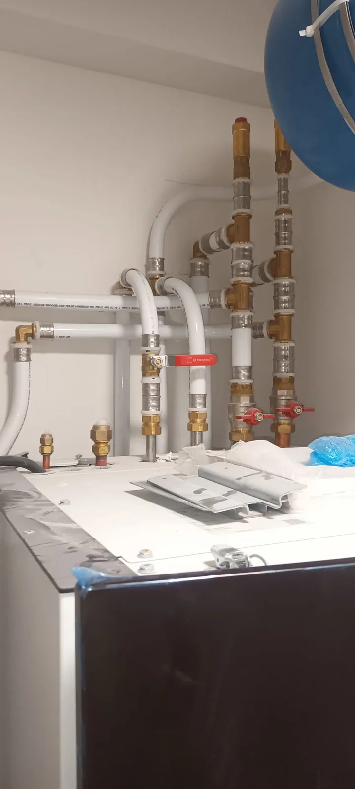 Tidy heating system pipework and valves above a new cylinder